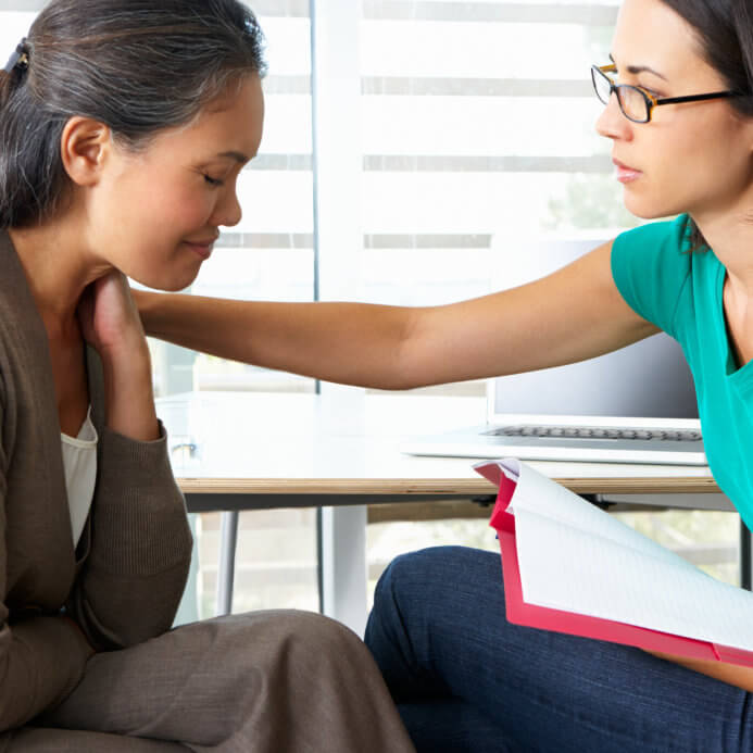 woman comforting a troubled woman