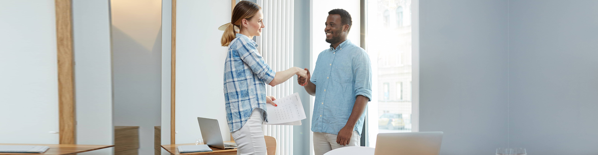 woman shaking hands with a man