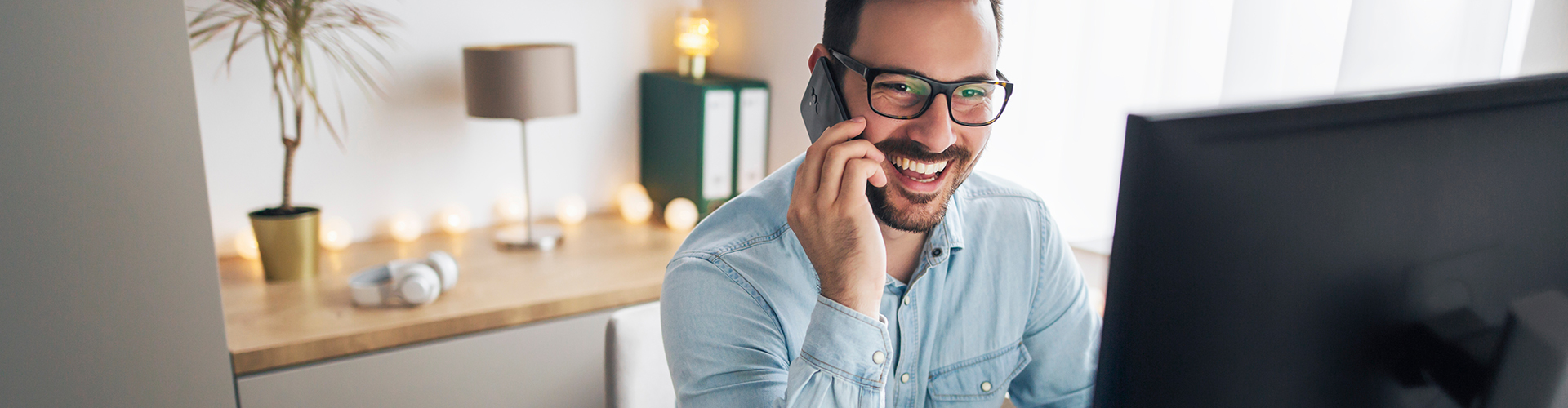 smiling man answering a phone call